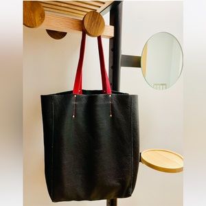 Roots black leather tote bag with red accents